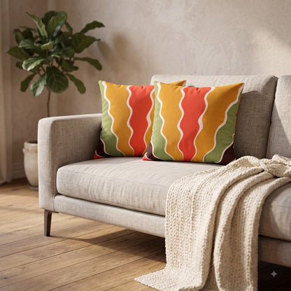 Sunset Ripple Flow cushion covers styled on a neutral sofa with a knitted throw